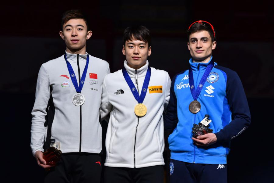 Wang Pengyu (CHN) Chang Hyun Woo (KOR) Pietro Sighel (ITA) 2019©ISU 1089881502